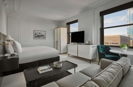 Pendry Chicago gay-friendly hotel room. Modern design with a bed, sofa, and city views. Upscale lodging for gay travelers in Chicago.