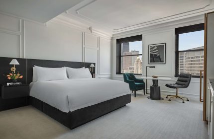 Pendry Chicago gay-friendly hotel room. Modern interior with a king bed, desk, and city views. Upscale lodging for gay travelers.