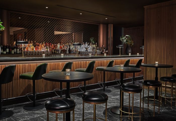 Pendry Chicago gay-friendly hotel bar. Stylish interior with bar stools, tables, and a well-stocked bar. Elegant design for gay travelers.
