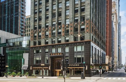 Pendry Chicago, a gay-friendly hotel. The Carbide and Carbon Building's Art Deco facade, a luxury destination for LGBTQ+ travelers.