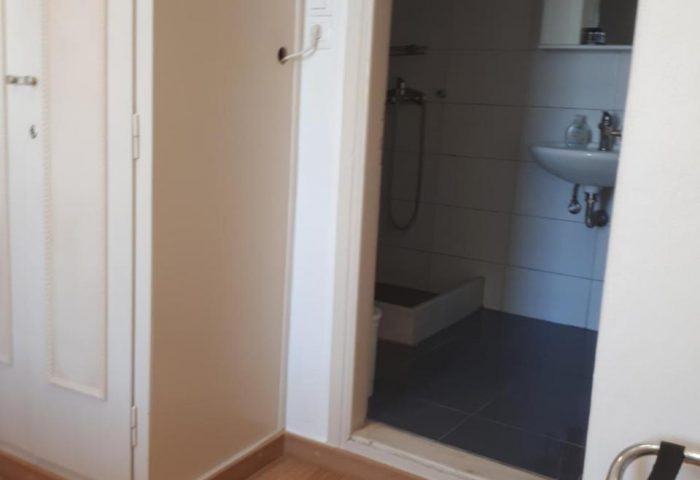 Pension Ageliki Kalogera's bathroom. Gay-friendly hotel room with sink, mirror, and shower. Comfortable stay for gay travelers.