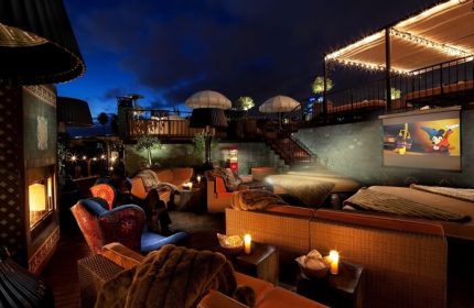 Petit Ermitage Hotel's rooftop cinema. Gay-friendly, adults-only hotel with cozy seating, blankets, and a movie screen under the night sky.