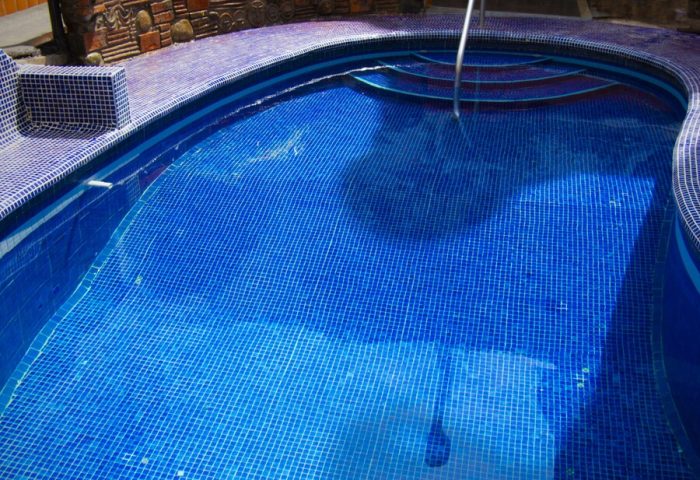 Blue tiled pool at Gay-Friendly Petit Hotel Pilitas. Steps lead into the water. Relaxing gay travel destination.