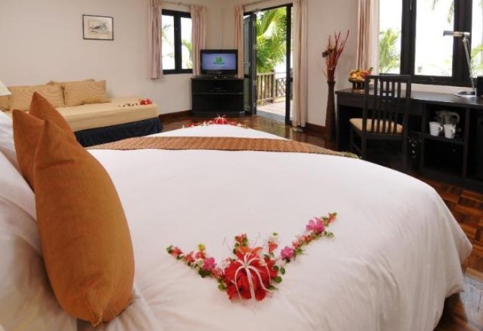 Gay-friendly Phi Phi Holiday Resort room. King bed with flowers, desk, balcony. Ideal gay travel at Phi Phi Holiday Resort.
