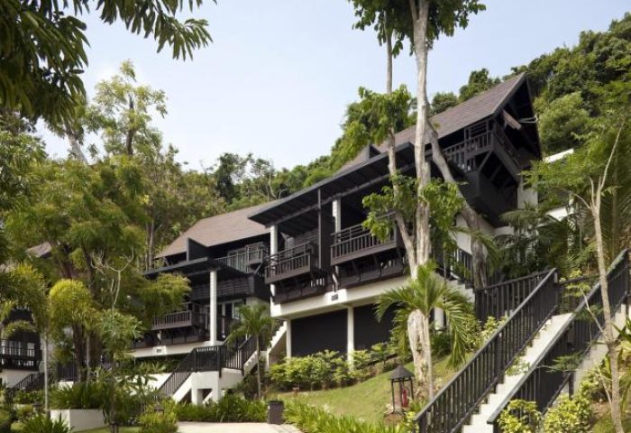 Phi Phi Holiday Resort: exterior view of a gay-friendly hotel on Phi Phi Island. Lush greenery surrounds the modern building with balconies.
