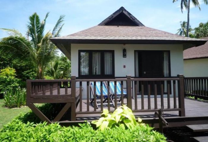 Phi Phi Holiday Resort bungalow with deck and chairs. Gay-friendly hotel in Phi Phi, Thailand. Tropical vacation getaway.