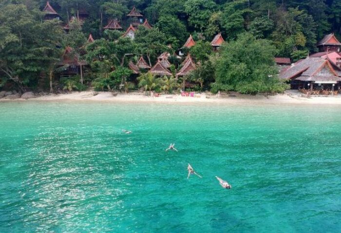 Phi Phi Relax Beach Resort: Gay-friendly hotel with turquoise water, beach, and swimmers. Tropical paradise for gay men travelers.
