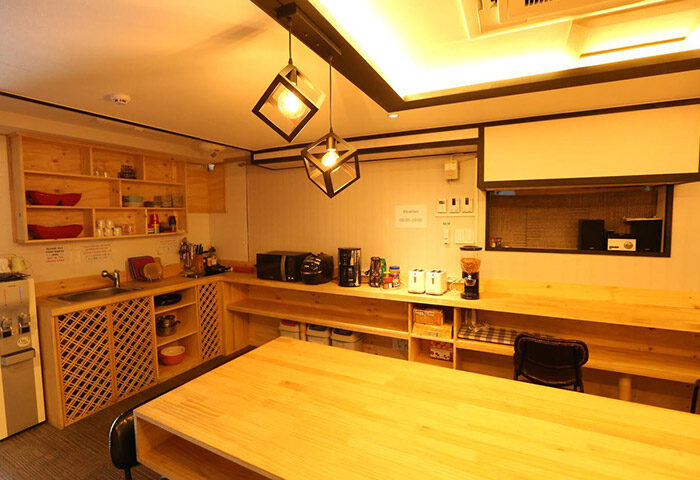 Philstay Itaewon Guesthouse's kitchen. This gay-friendly hotel in Seoul features a communal kitchen with wooden cabinets and modern appliances.
