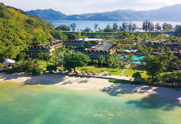 Aerial view of Phuket Marriott Resort & Spa, Merlin Beach. Gay-friendly hotel with pools, beach access, and lush tropical landscape.