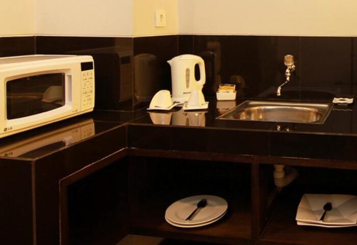 Ping Hotel Seminyak kitchenette. Gay-friendly hotel room features microwave, kettle, and sink. A comfortable stay in Seminyak, Bali.