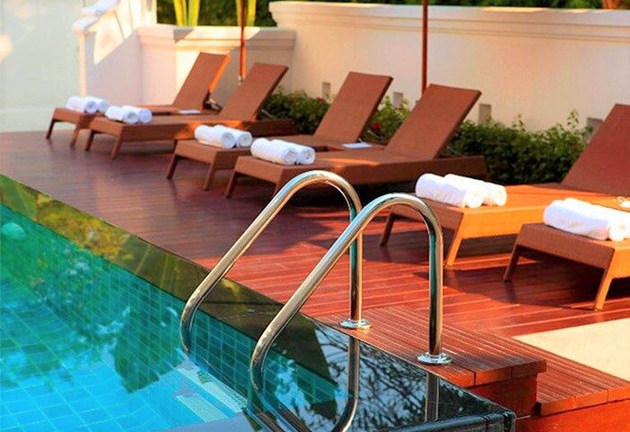 Ping Nakara Boutique Hotel and Spa pool. Loungers with towels line the pool at this gay-friendly hotel, a relaxing spot for gay travel.