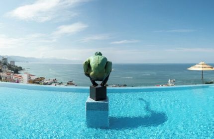 Infinity pool at Pinnacle Resorts 179 Adults Only, a gay-friendly hotel. Ocean view with sculpture. Gay travel in Puerto Vallarta.