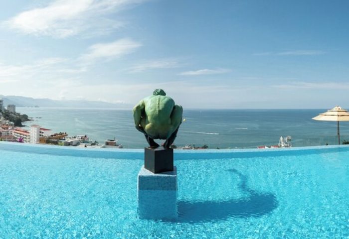 Infinity pool at Pinnacle Resorts 179 Adults Only, a gay-friendly hotel. Ocean view with sculpture. Gay travel in Puerto Vallarta.