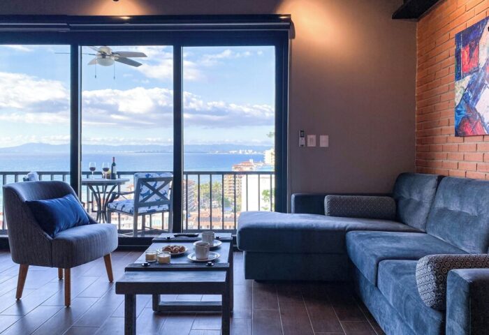 Pinnacle Resorts 179 adults-only gay-friendly hotel living room. Ocean view from balcony. Modern interior design, Puerto Vallarta.