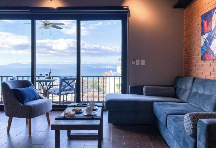 Pinnacle Resorts 179 adults-only gay-friendly hotel living room. Ocean view from balcony. Modern interior design, Puerto Vallarta.