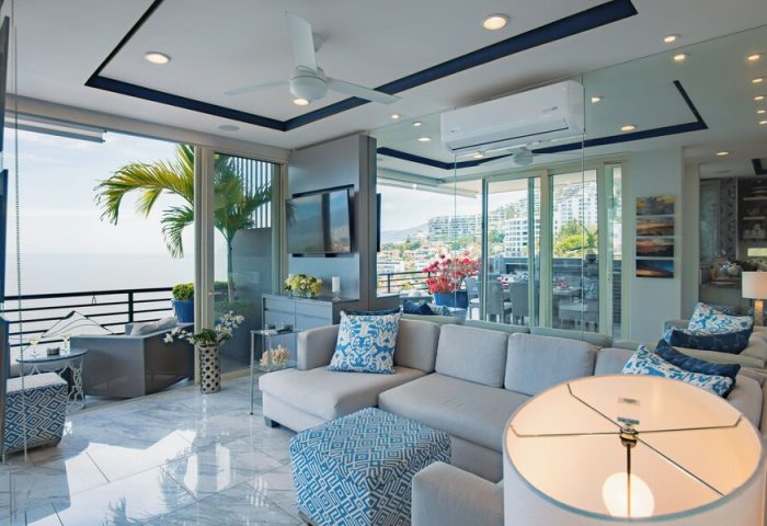 Pinnacle Resorts 180 living room. Gay-friendly hotel with ocean view, balcony, modern decor, sofa, and stylish blue accents. Perfect for gay travel.