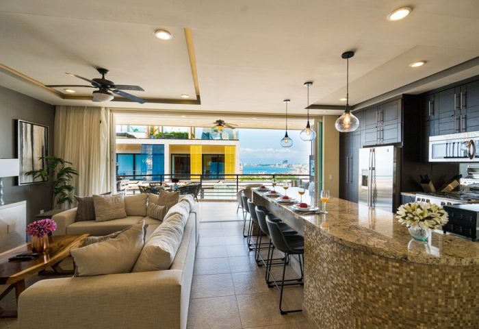 Pinnacle Resorts 180 gay-friendly hotel suite. Living area, kitchen bar, and balcony with ocean view. Upscale gay travel accommodation.