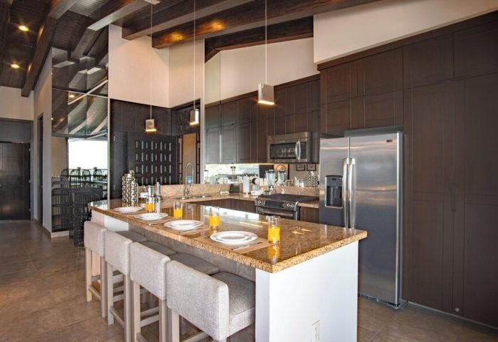 Modern kitchen at Pinnacle Resorts 180, a gay-friendly hotel. Features island seating, stainless steel appliances, and stylish design.
