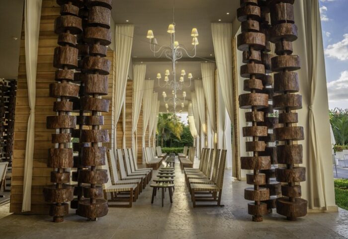 Platinum Yucatan Princess All Inclusive Suites & Spa Resort Adults Only lobby. Wood decor, chandeliers, chairs, and curtains. Gay-friendly hotel.