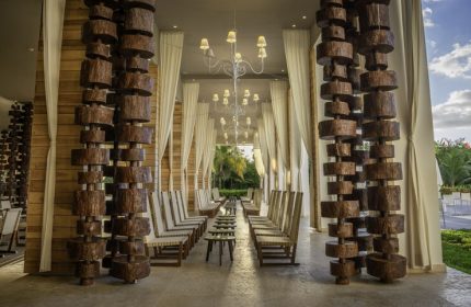Platinum Yucatan Princess All Inclusive Suites & Spa Resort Adults Only lobby. Wood decor, chandeliers, chairs, and curtains. Gay-friendly hotel.