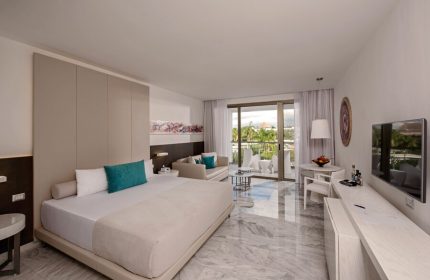 Platinum Yucatan Princess suite interior. All-inclusive, adults-only, gay-friendly hotel room with balcony. Modern decor, luxury resort.