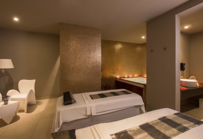 Spa room at Platinum Yucatan Princess All Inclusive Suites Resort Adults Only. Massage beds, jacuzzi, and modern decor for a relaxing getaway. Gay-friendly hotel.