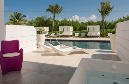 Platinum Yucatan Princess All Inclusive Suites and Spa Resort Adults Only gay-friendly hotel. Poolside view with lounge chairs and jacuzzi.