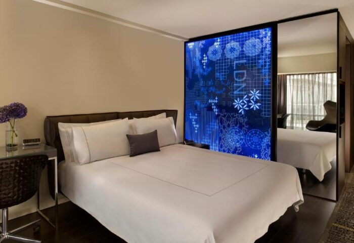 Park Plaza London Riverbank gay-friendly hotel room. Modern design, double bed, desk, and blue decorative panel. Pet-friendly travel.