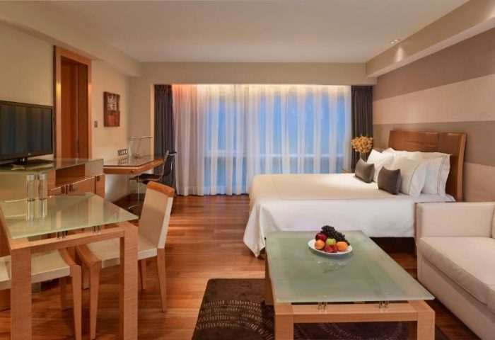 Park Plaza London Riverbank gay-friendly hotel room. Plaza on the River Club & Residence pet-friendly suite with bed, desk, and seating area.