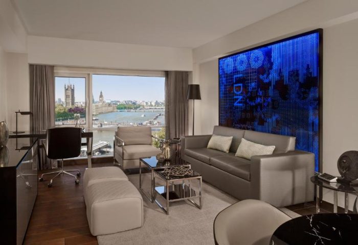 Park Plaza London Riverbank gay-friendly hotel room. Interior view with sofa, desk, and view of Houses of Parliament. Pet-friendly.