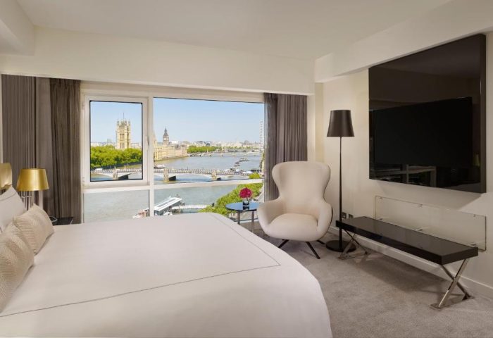 Park Plaza London Riverbank gay-friendly hotel room. River view, chair, TV, and bed. Plaza on the River Club and Residence. Pet-friendly.