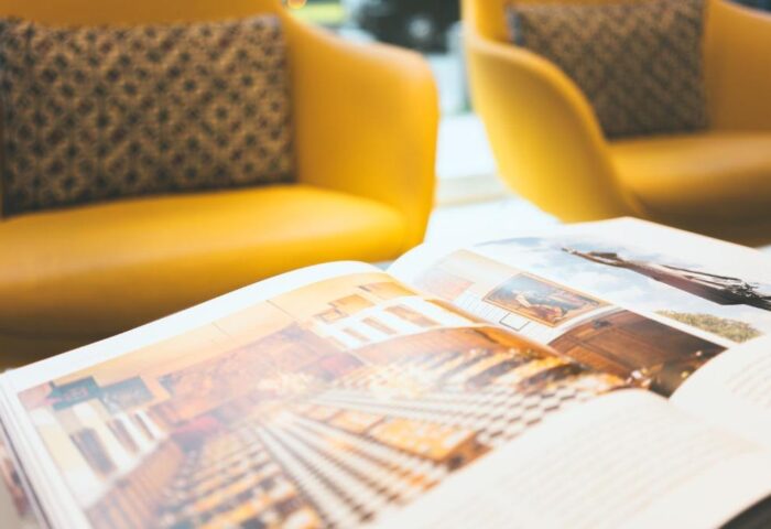 Point A Hotel London Westminster: Open book on table, yellow chairs in background. Gay-friendly hotel, travel advice for gay men.