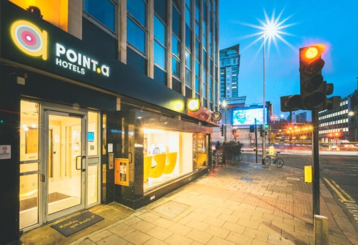 Point A Hotel London Westminster exterior at dusk. Gay-friendly hotel with modern design. Cityscape view. Great location for gay travelers.