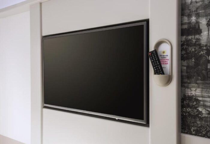 TV and remote in a room at Point A Hotel London Westminster, a gay-friendly hotel. Modern design for gay travelers.