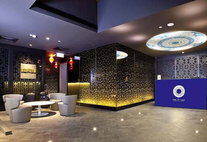 Lobby of Porcelain Hotel by JL Asia, a gay-friendly hotel. Modern design with Asian accents. Seating area and reception desk. Upscale, stylish.