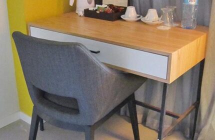 Prima City Tel Aviv Hotel room desk. Gay-friendly hotel room detail with chair, desk, water bottle, coffee cups, and tea.