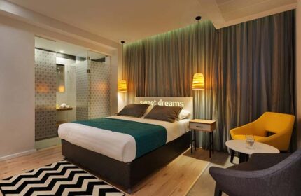 Prima City Tel Aviv Hotel room. Gay-friendly hotel with a modern design, featuring a comfortable bed and a stylish bathroom. Tel Aviv travel.