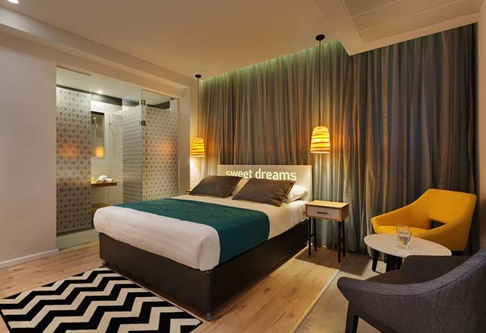 Prima City Tel Aviv Hotel room. Gay-friendly hotel with a modern design, featuring a comfortable bed and a stylish bathroom. Tel Aviv travel.