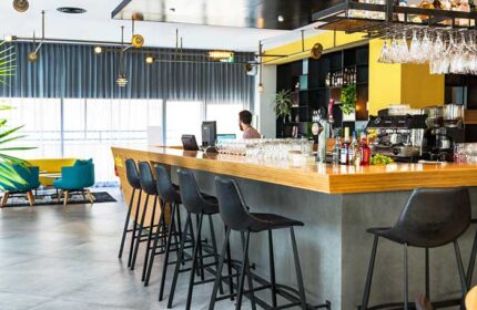 Prima City Tel Aviv Hotel bar area. Gay-friendly hotel with modern design, bar stools, and a well-stocked bar. Great spot for gay travelers.