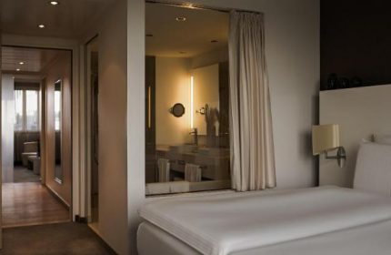 Pullman Berlin Schweizerhof Hotel room. Gay-friendly hotel with modern design. Bedroom view to bathroom. Great for gay travelers in Berlin.