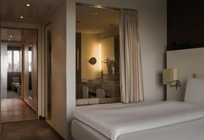 Pullman Berlin Schweizerhof Hotel room. Gay-friendly hotel with modern design. Bedroom view to bathroom. Great for gay travelers in Berlin.