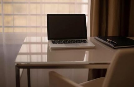 Laptop and notebook on a desk at Pullman Berlin Schweizerhof Hotel. Gay-friendly hotel room in Berlin, Germany.