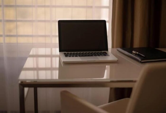 Laptop and notebook on a desk at Pullman Berlin Schweizerhof Hotel. Gay-friendly hotel room in Berlin, Germany.