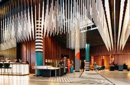 Pullman Berlin Schweizerhof Hotel lobby. Gay-friendly hotel with modern design, unique lighting, and reception area. Upscale Berlin hotel.