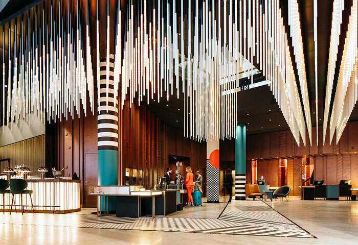 Pullman Berlin Schweizerhof Hotel lobby. Gay-friendly hotel with modern design, unique lighting, and reception area. Upscale Berlin hotel.