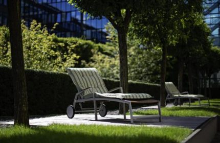 Lounge chairs in the garden of the gay-friendly Pullman Berlin Schweizerhof Hotel. Relaxing outdoor space for gay travelers in Berlin, Germany.