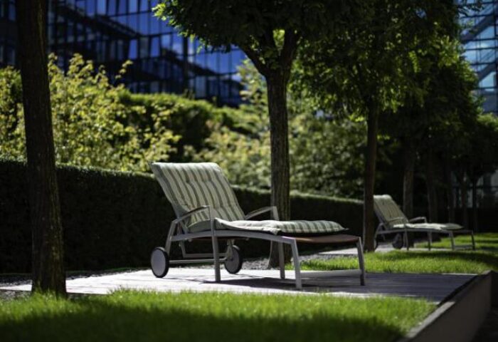 Lounge chairs in the garden of the gay-friendly Pullman Berlin Schweizerhof Hotel. Relaxing outdoor space for gay travelers in Berlin, Germany.