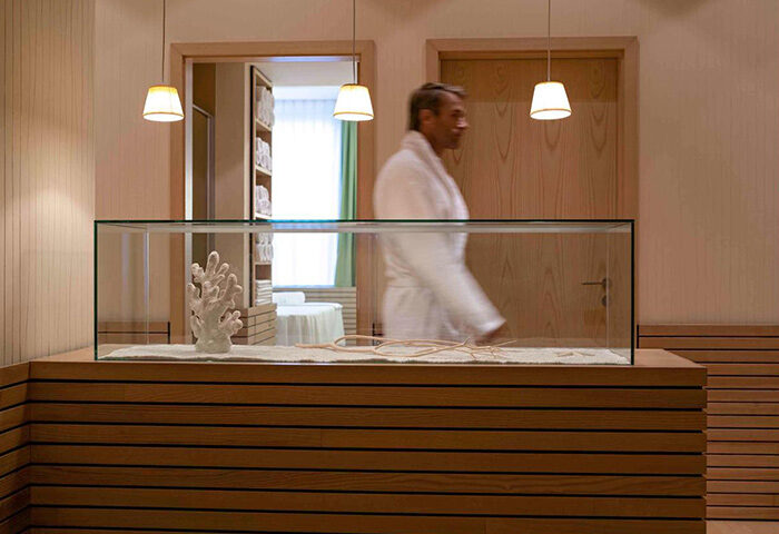 Pullman Berlin Schweizerhof Hotel spa. Man in robe. Gay-friendly hotel with modern design. Relaxing travel for gay men in Berlin.
