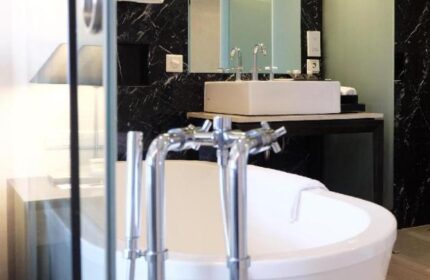 Pullman Jakarta, Indonesia gay-friendly hotel bathroom. Features a modern bathtub, sink, and marble accents. Ideal for gay travelers.