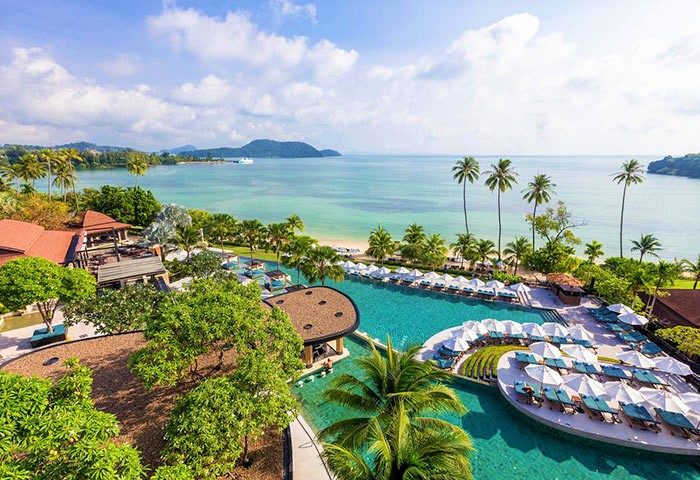 Gay-friendly Pullman Phuket Panwa Beach Resort SHA-certified. Aerial view of pools, beach, and ocean. Tropical gay travel in Thailand.